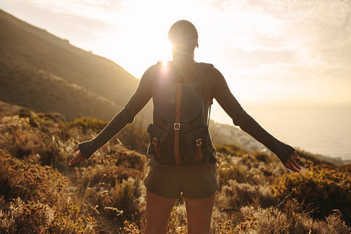 Female hiker embracing the sun light