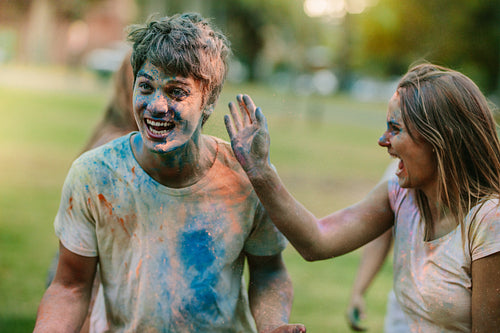 Happy couple playing holi