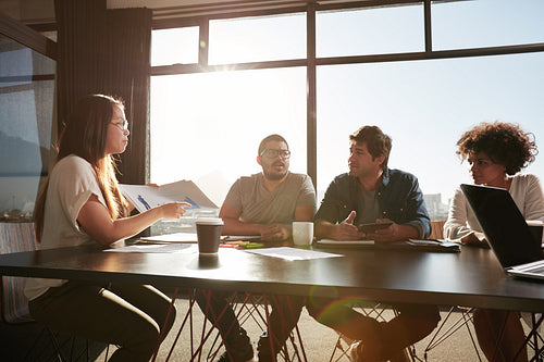 Woman consulting new business plans with her colleagues