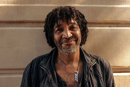 Underprivileged man smiling at the camer outdoors