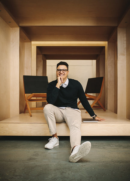 Smiling businessman sitting in office inside an enclosure