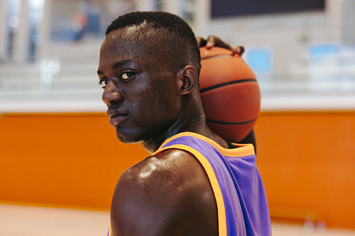 Confident basketball player holding the ball ready for the next play