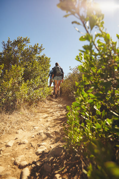 Couple hiking on dirt trial on mountain