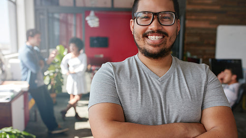 Smiling male designer looking at camera at office