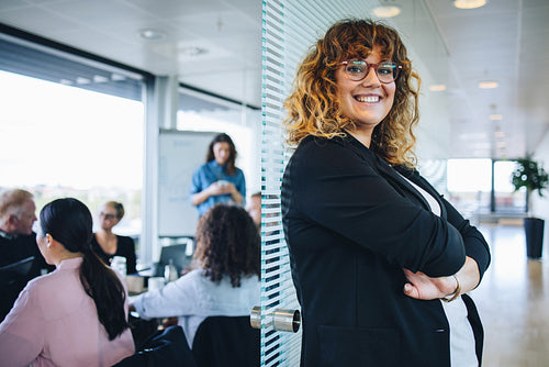 Portrait of smiling businesswoman standing in office