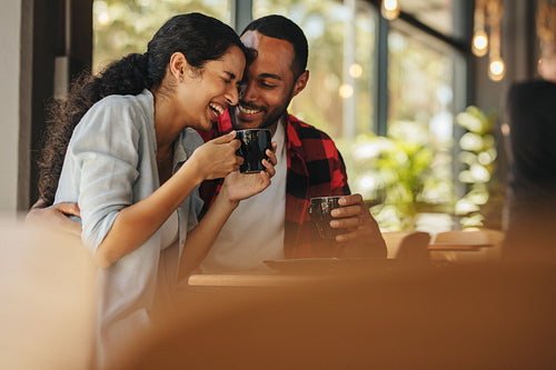 Couple talking over a cup of coffee at cafe