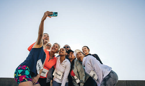Group of friends taking a selfie during a road race event