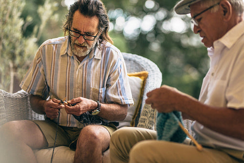 Retired male friends doing knitting for pastime
