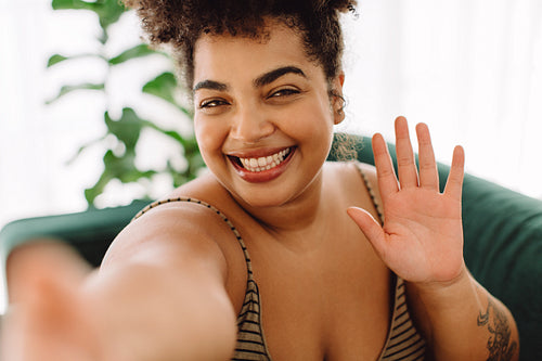 Beautiful woman waving hand taking selfie