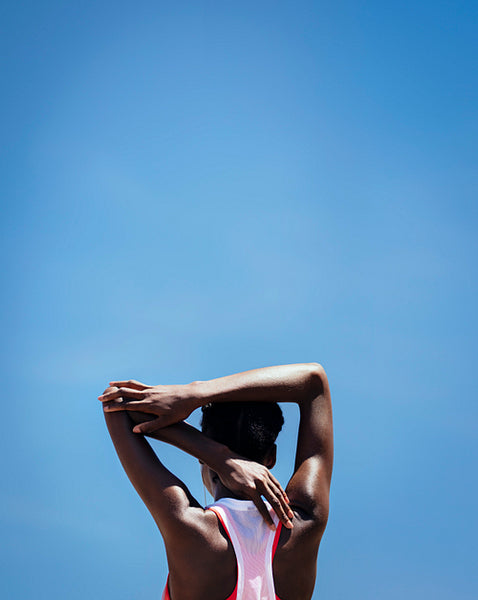 Fitness woman doing warmup exercise outdoors
