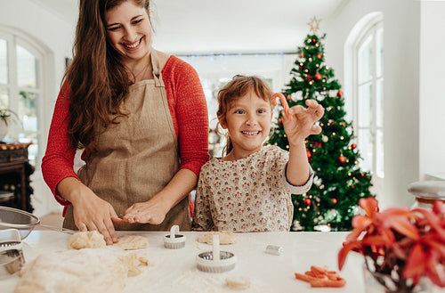 Mother and daughter making cookies for Christmas.