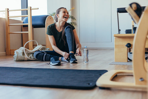 Woman at a pilates gym getting ready to leave