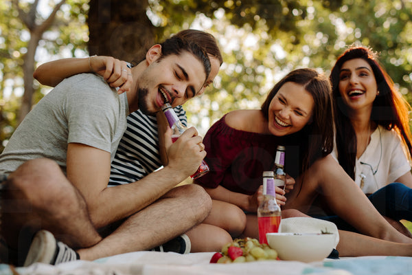 Friends enjoying drinks at picnic
