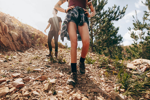 Couple on a holiday hiking down a rugged hilly terrain
