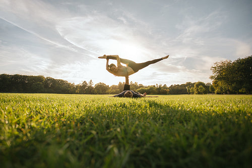 Fit young couple doing acro yoga