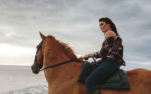 Woman riding a horse outdoors