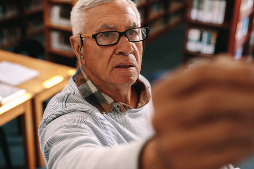 Close up of a professor teaching in classroom writing on board