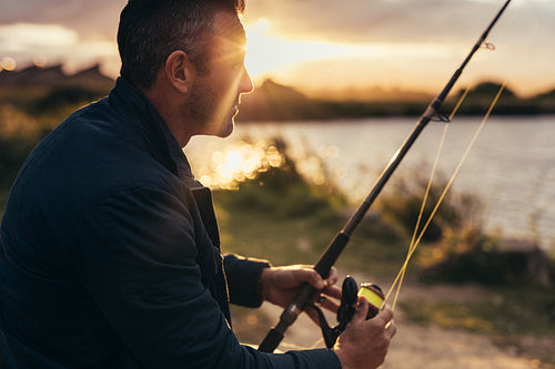 Man fishing near a lake