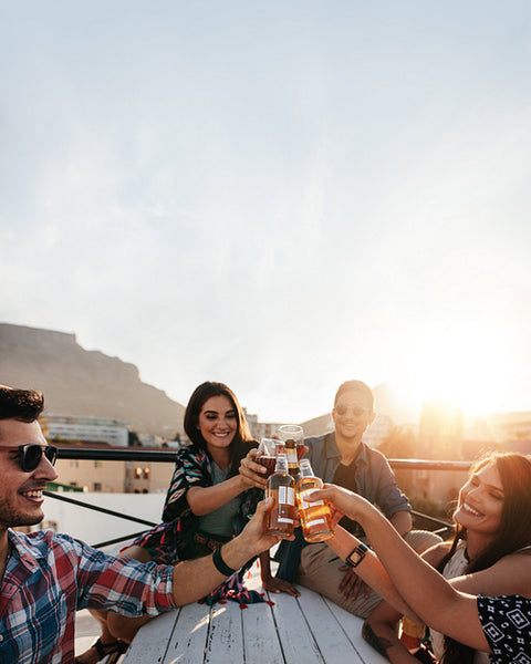 People celebrating with drinks at rooftop party