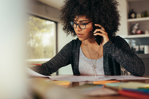Female architect talking with client over phone