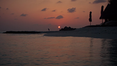 Beautiful island sunset reflects on tranquil ocean waves