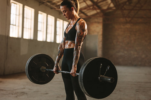 Strong woman exercising with heavy weights