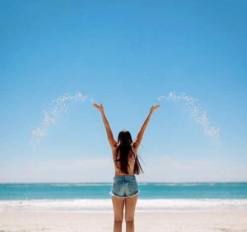 Woman enjoying her holiday playing at the beach