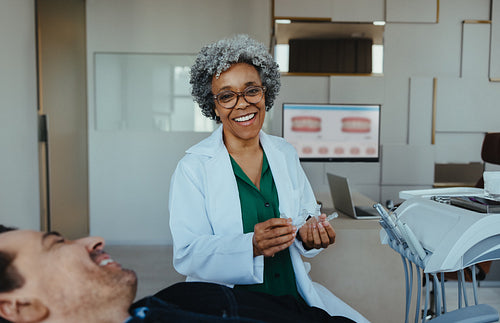 Dentist reviews a dental aligner with a patient in a modern orthodontic clinic