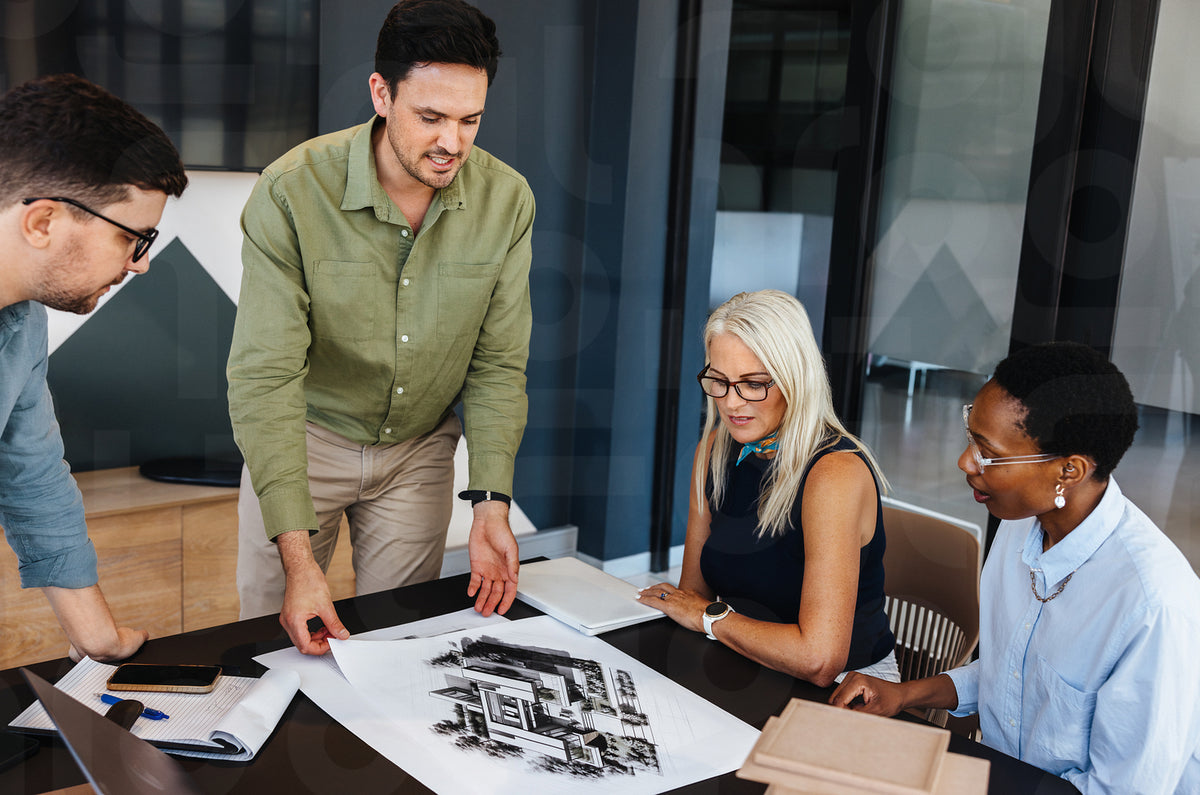 Team discussing architectural designs in a modern office space – Jacob ...