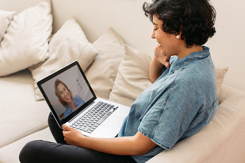 Women friends video calling on laptop