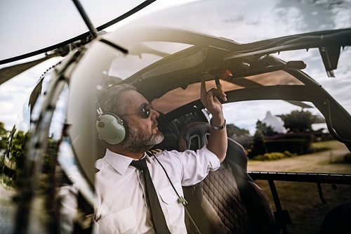 Pilot starting the controls on helicopter