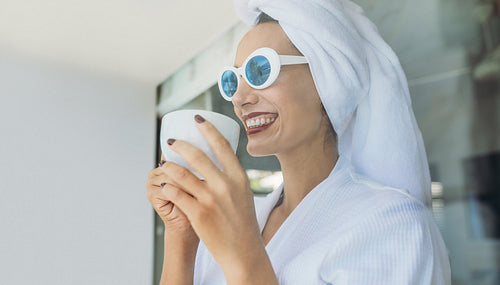 Woman having coffee after shower