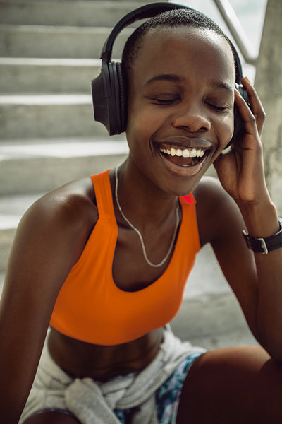 Sporty woman listening music after training