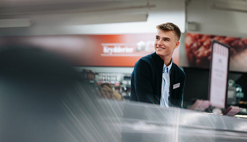 Man on a holiday job at grocery store