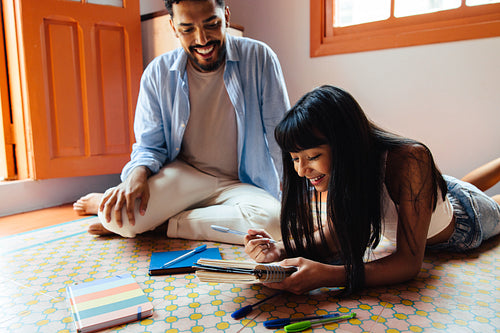 Father and daughter enjoying a relaxed moment together in a cozy indoor setting