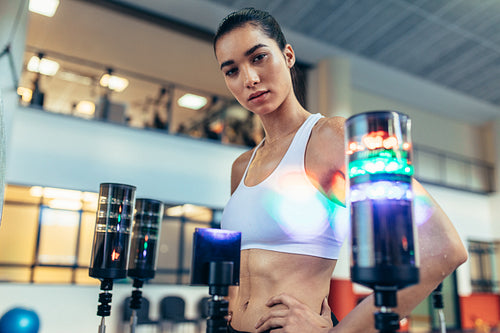 Confident sportswoman with lights around