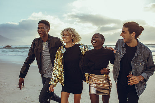 Group of diverse friends walking at the beach