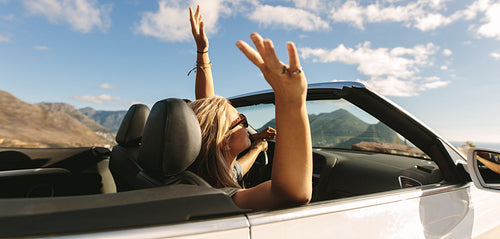 Couple on road trip enjoying in a cabriolet