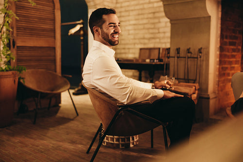 Happy young tourist man smiling cheerfully in a luxury hotel