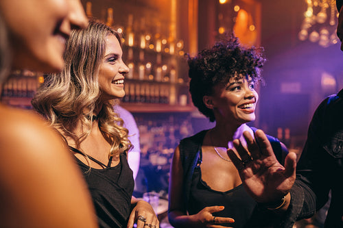 Group of young friends enjoying a night at pub