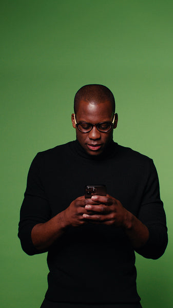 Happy man using smartphone on green screen background