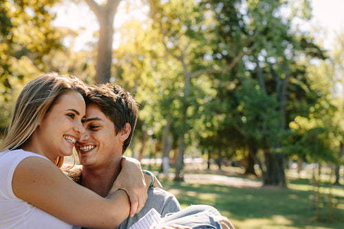 Close up of a smiling man carrying his girlfriend in arms