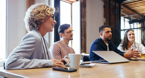 Business discussion in a conference meeting, business people sit together on a table in an office