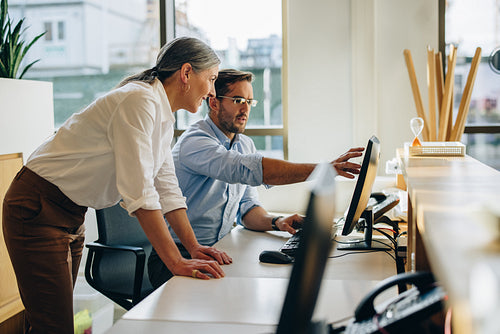 Two business people working together in office