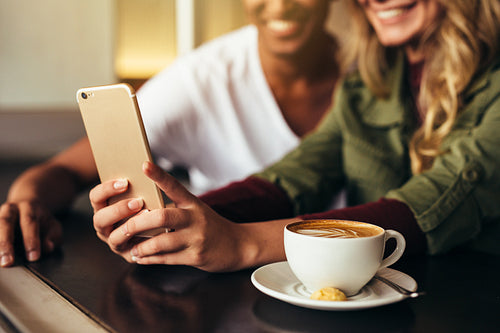 Friends making selfie at coffee shop