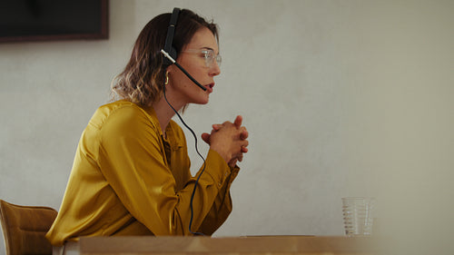 Customer service professional on a video call in her office