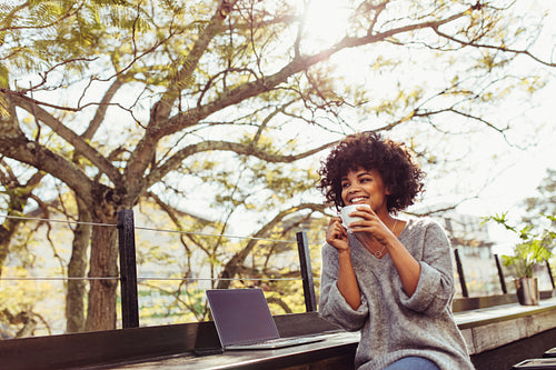 Young woman drinking coffee outdoors