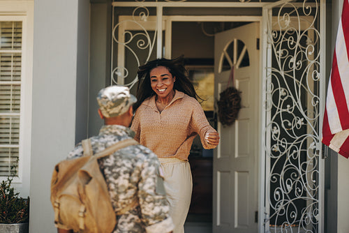 Excited military wife welcoming her husband from the army
