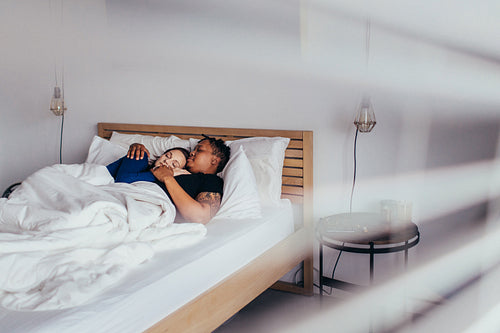 Loving couple sleeping on bed