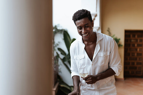 Happy young man laughing cheerfully on a balcony